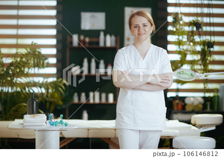 female massage therapist in massage cabinet looking at camera female massage therapist in massage cabinet looking at camera 106146812