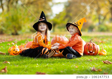 Kids with pumpkins in Halloween costumes Kids with pumpkins in Halloween costumes 106147753