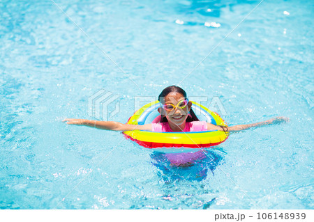 Child in swimming pool on toy ring. Kids swim. Child in swimming pool on toy ring. Kids swim. 106148939