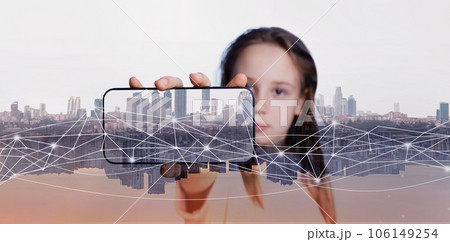 Smartphone in hand of child girl on modern city background 106149254