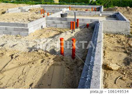 Building the foundation of the house from concrete blocks and installation of pipework system Building the foundation of the house from concrete blocks and installation of pipework system 106149534