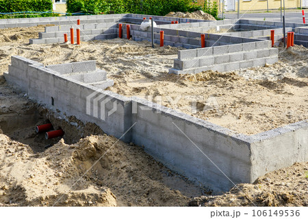 Building the foundation of the house from concrete blocks and installation of pipework system Building the foundation of the house from concrete blocks and installation of pipework system 106149536