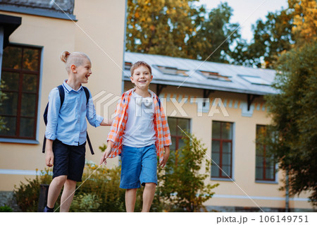 smiling caucasian handsome children go home from school 106149751