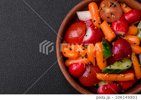 Delicious fresh juicy salad with radishes, tomatoes, carrots, cucumber, spices and herbs Delicious fresh juicy salad with radishes, tomatoes, carrots, cucumber, spices and herbs 106149801