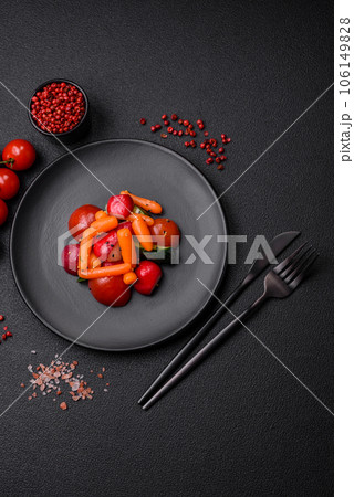 Delicious fresh juicy salad with radishes, tomatoes, carrots, cucumber, spices and herbs Delicious fresh juicy salad with radishes, tomatoes, carrots, cucumber, spices and herbs 106149828