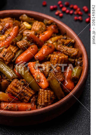 Mix of vegetables corn, carrots, peppers, broccoli, onions in teriyaki sauce on a ceramic plate Mix of vegetables corn, carrots, peppers, broccoli, onions in teriyaki sauce on a ceramic plate 106149842