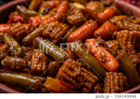 Mix of vegetables corn, carrots, peppers, broccoli, onions in teriyaki sauce on a ceramic plate Mix of vegetables corn, carrots, peppers, broccoli, onions in teriyaki sauce on a ceramic plate 106149846