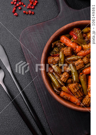 Mix of vegetables corn, carrots, peppers, broccoli, onions in teriyaki sauce on a ceramic plate Mix of vegetables corn, carrots, peppers, broccoli, onions in teriyaki sauce on a ceramic plate 106149861
