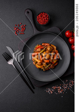 Mix of vegetables corn, carrots, peppers, broccoli, onions in teriyaki sauce on a ceramic plate 106149868