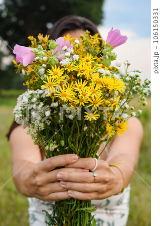 Focus shifts bouquet young woman stands picturesque meadow at twilight 106150331