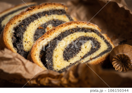 Pieces of strudel with poppy seeds on paper Pieces of strudel with poppy seeds on paper 106150344