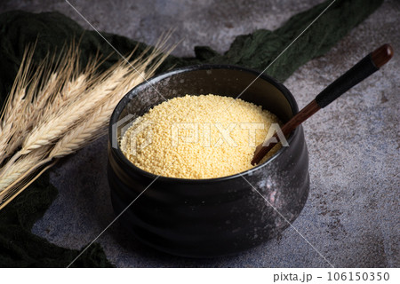Couscous in a black ceramic bowl 106150350