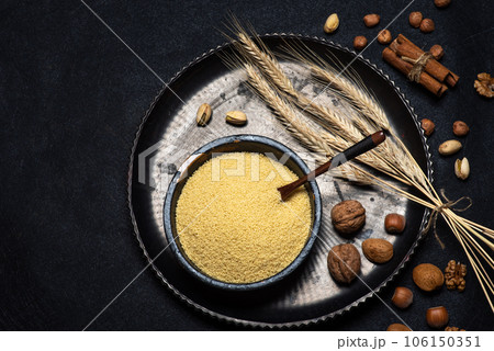 Couscous in a black ceramic bowl 106150351
