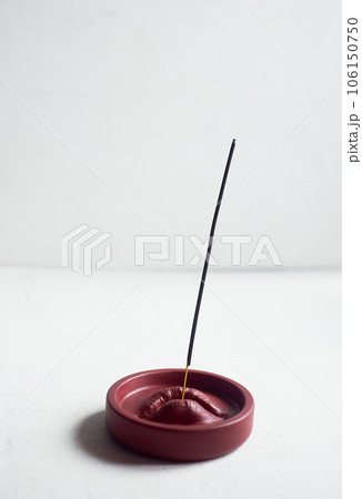 Incense stand red lips. Round shape on a white background. Esotericism, meditation Incense stand red lips. Round shape on a white background. Esotericism, meditation 106150750