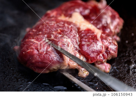 Rib-eye steaks on a gas grill. Chef cooking steak on a grill. 106150943