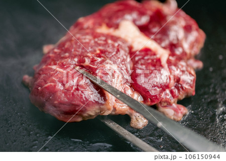 Rib-eye steaks on a gas grill. Chef cooking steak on a grill. 106150944