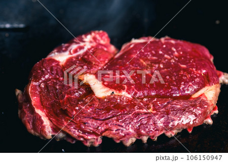 Rib-eye steaks on a gas grill. Chef cooking steak on a grill. 106150947