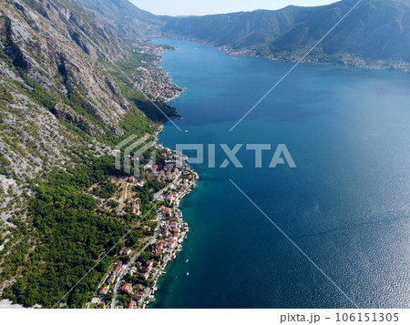 Aerial drone high view of Kotor bay, Boka Kotorska and coastal town Kotor, Cattaro, in Montenegro. Location place famous resort Montenegro. Adriatic fjord surrounded by rugged mountains Aerial drone high view of Kotor bay, Boka Kotorska and coastal town Kotor, Cattaro, in Montenegro. Location place famous resort Montenegro. Adriatic fjord surrounded by rugged mountains 106151305