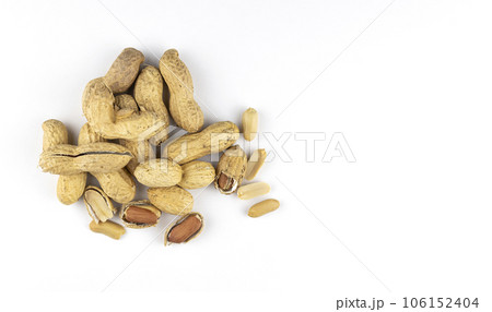 Raw peanuts on a white background, top view. Unshelled peanuts. 106152404