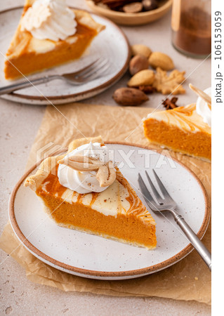 Pumpkin cheesecake swirl pie topped with whipped cream 106153059