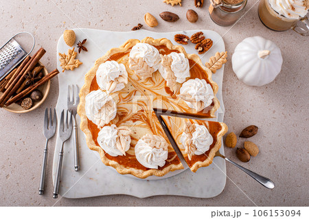 Pumpkin cheesecake swirl pie topped with whipped cream 106153094