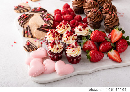 Valentines day charcuterie board with cupcakes and strawberries Valentines day charcuterie board with cupcakes and strawberries 106153191