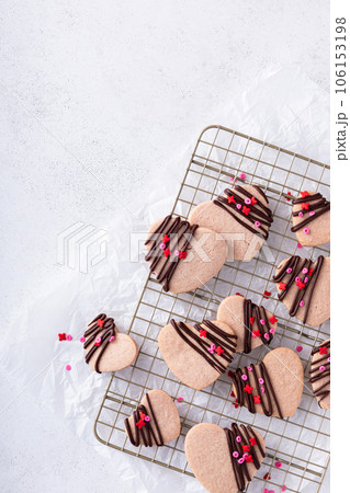 Heart shaped strawberry cut out cookies with dark chocolate 106153198
