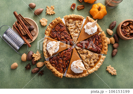 Traditional fall Thanksgiving pie slices, pumpkin and pecan pie 106153199