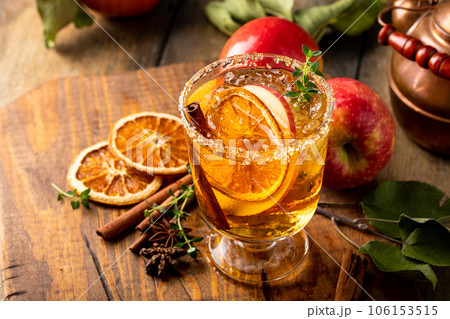 Festive fall cocktail or mocktail with hard cider, apple and orange 106153515