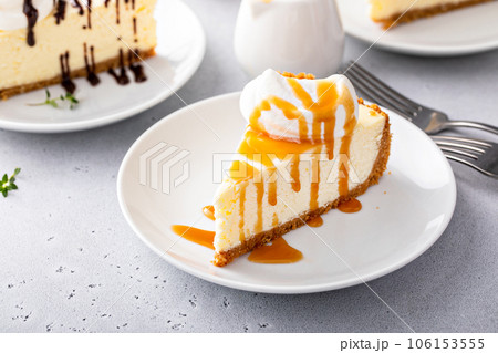 Slice of a traditional New York cheesecake with whipped cream Slice of a traditional New York cheesecake with whipped cream 106153555