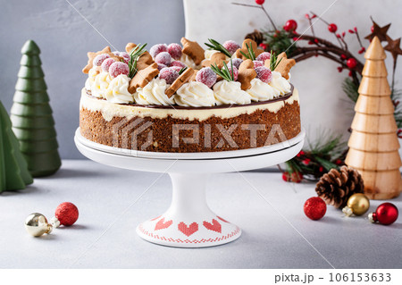 Christmas cake decorated with gingerbread cookies and sugared cranberry Christmas cake decorated with gingerbread cookies and sugared cranberry 106153633