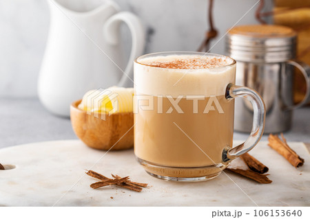 Bulletproof coffee in a glass mug with cinnamon 106153640
