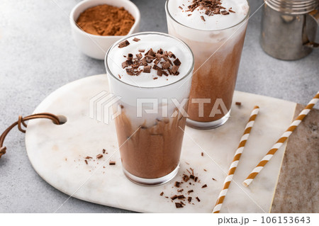 Cold hot chocolate in tall glasses with milk foam 106153643