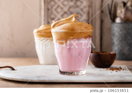Strawberry dalgona whipped coffee in a glass with ice 106153651