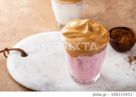 Strawberry dalgona whipped coffee in a glass with ice 106153652