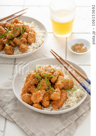 Orange chicken in a bowl served with rice Orange chicken in a bowl served with rice 106153692