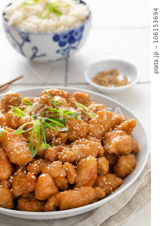 Orange chicken in a bowl served with rice 106153694