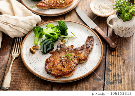 Grilled or pan fried pork chops on the bone 106153812