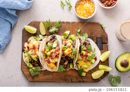 Breakfast tacos with sausage, eggs, bacon and avocado Breakfast tacos with sausage, eggs, bacon and avocado 106153821