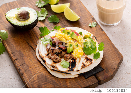 Breakfast tacos with sausage, eggs, bacon and avocado 106153834