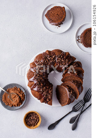 Chocolate cake baked in a bundt pan with chocolate ganache glaze Chocolate cake baked in a bundt pan with chocolate ganache glaze 106154926