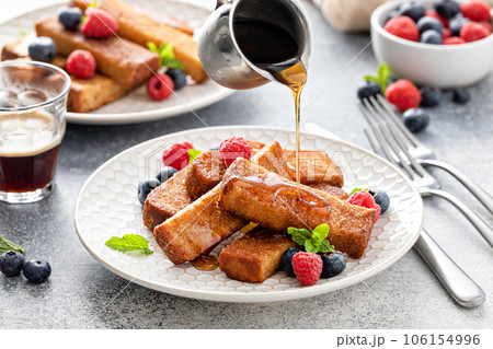 French toast sticks with maple syrup and berries 106154996