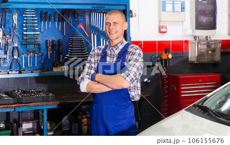 Professional auto mechanic posing in workshop Professional auto mechanic posing in workshop 106155676