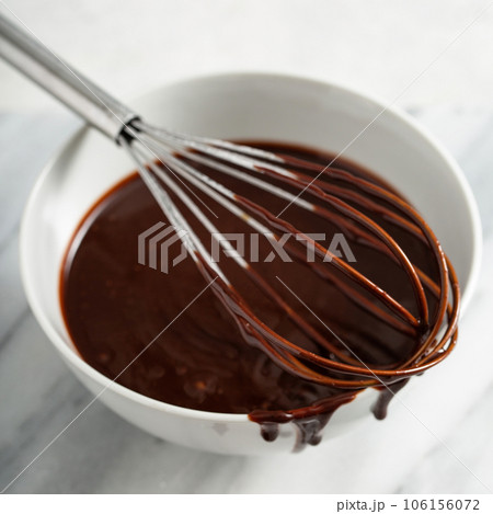 Making chocolate glaze or sauce 106156072