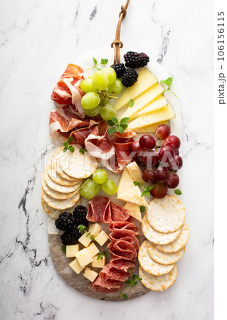 Charcuterie board with variety of cheese and meat Charcuterie board with variety of cheese and meat 106156115