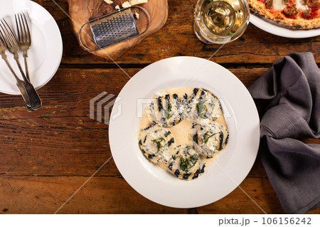 Freshly made seafood and cheese ravioli with creamy sauce 106156242