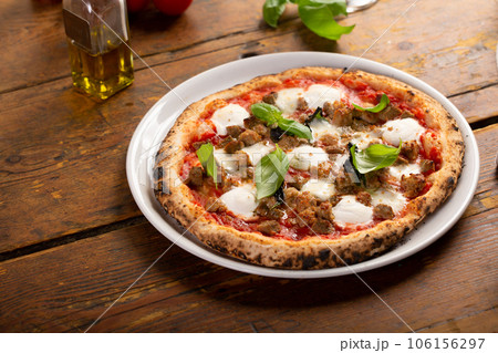 Freshly baked Neapolitan pizza with mozzarella and basil 106156297
