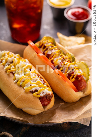 Two hot dogs with ketchup and mustard 106156346