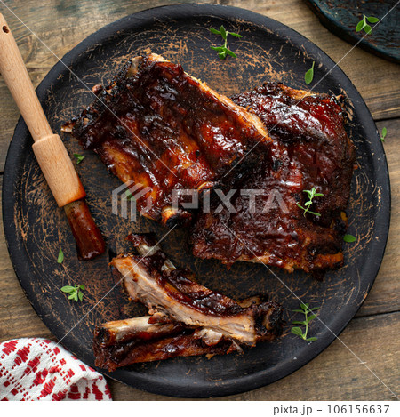 Grilled barbeque ribs with BBQ sauce and sides Grilled barbeque ribs with BBQ sauce and sides 106156637