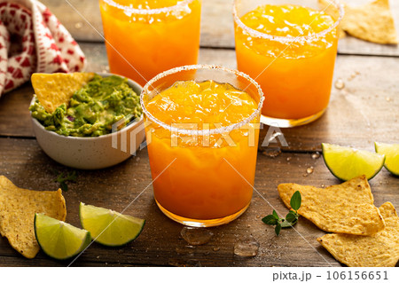 Pineapple and mango margarita with chips and guacamole 106156651
